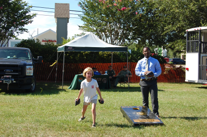 Deputy playing and outdoor game with children