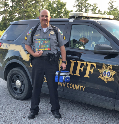 School resource deputy standing in front of Vehicle