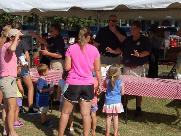 Deputy serving food to citizens outdoor