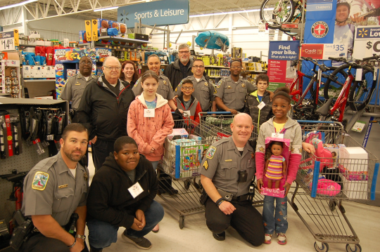 Deputies in a toy store with children