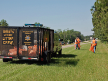 Inmates picking up litter on the highway